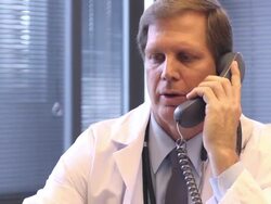 Male Doctor Discusses Radiology Slides on Phone Stock Footage
