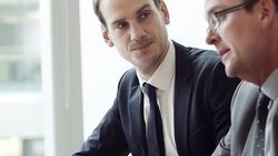 Businessmen talking and working at laptop Stock Footage