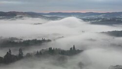 Looking down into the Langdale Valley above valley mist formed by a temperature inversion on Loughrigg, near Ambleside in the Lake District National Park. Stock Footage