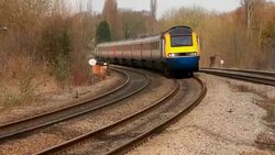 East Midlands express train rounds a bend on the Midland Mainline Stock Footage