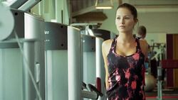 Woman stretching arms near exercise machines at gym Stock Footage