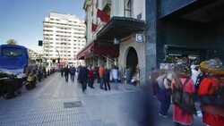 Pedestrians move along the sidewalk on the Boulevard de Rachidi. Stock Footage