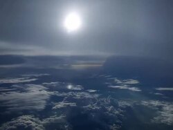 WS AERIAL T/L View of Travelling above and below misty layers with small cloud islands lit by sun / In Flight, Indonesia Stock Footage