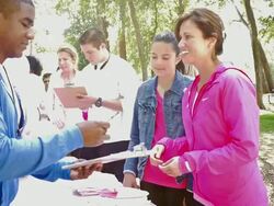 Diverse participants registering for breast cancer awareness race Stock Footage