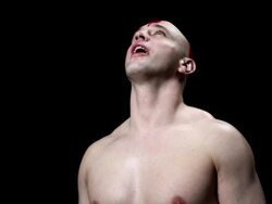Man with red cross painted on his head, head back Stock Footage