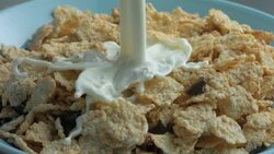 Milk pours on cereal in slow motion. Stock Footage