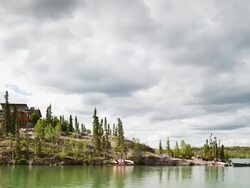WS T/L View of Rolling clouds over romote lodge / Yellowknife, Northwest Territories, Canada  Stock Footage