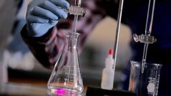 Hands of students conducting lab experiment Stock Footage