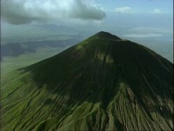 WA aerial view of green mountain, shadows of cloud on mountain, Africa Stock Footage