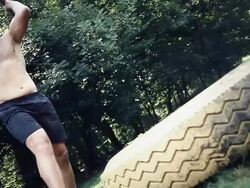 HD SLOW MOTION: Athlete Whacking A Truck Tire Stock Footage