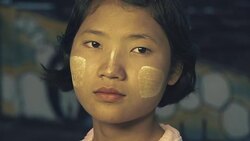 C/U Burmese teenage girl in an urban flat roof in an abandoned building at sundown Stock Footage