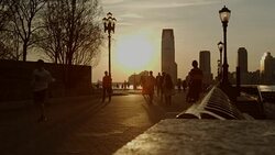 Sunset Battery Park NYC people enjoying the warm weather Stock Footage