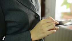 Businesswoman using a smartphone. Stock Footage