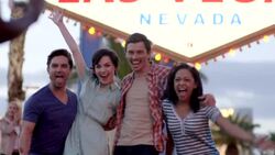 Friends pose for picture in front of Las Vegas sign Stock Footage