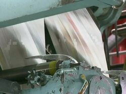 CU Paper running through printing press with name plaque in foreground, San Francisco, California, USA / AUDIO Stock Footage