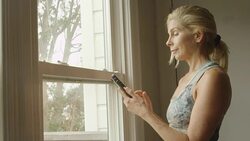 A mature woman tracks her workout progress on her phone. Stock Footage
