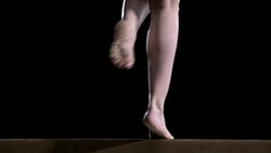 SLO MO Legs of gymnast at turn on balance beam Stock Footage