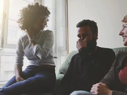 Young friends talking by a window Stock Footage
