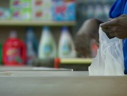 CU Shot of man filing plastic shopping bag in supermarket / Minneapolis, Minnesota, United States Stock Footage