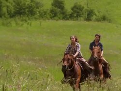 Two girls race on horses Stock Footage
