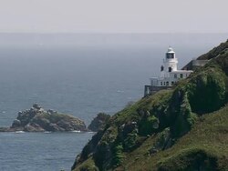 WS AERIAL View approaching to light house and sea / Guernsey, Channel Isles Stock Footage