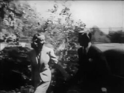 B/W 1939 newlyweds Clark Gable + Carole Lombard holding hands + walking past press / newsreel Stock Footage
