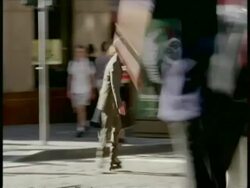 MS business man on rollerblades weaves in and out of traffic and pedestrians Stock Footage