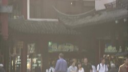 Shoppers stroll past storefronts at Ju Yuan Market in Shanghai, China. Stock Footage