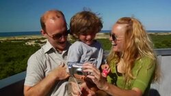 MS, Family with son (4-5) photographing self on beach, Provincetown, Massachusetts, USA Stock Footage