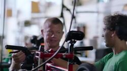 Employee explains brake lever issues to boss in bicycle repair shop Stock Footage