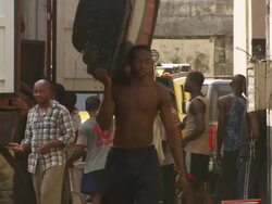 MS Shot of truck with people taking old televisions out of truck / Lagos, Nigeria Stock Footage