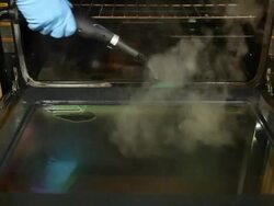 Steam Cleaning Kitchen Oven Interior Stock Footage