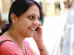 Indian Woman talking on the phone in a Shopping Mall Stock Footage