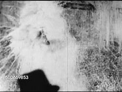 1920s: PROHIBITION: BEHIND Two men throwing, breaking liquor bottles on wall, MS Bottles in crate, breaking more bottles. WS Men opening barrels of liquid by city sidewalk, MS Liquid flowing from barrel, possibly beer, male filling bottle curbside. Instructional Video