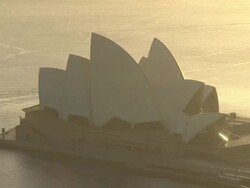 Sydney Opera House lit by early morning sunshine News Clip