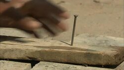 A carpenter nails boards together at the Sankat Mochan Temple in Diwali, India. Stock Footage