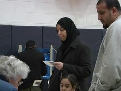 November 2, 2010 ZO Arab woman holding her ballot with fellow voters in the midterm election at Salina School in the 14th Congressional District / Dearborn, Michigan, United States Stock Footage