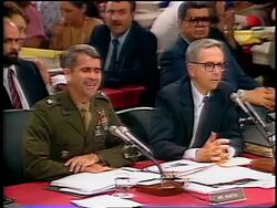 July, 1987 Oliver North talking to lawyer (Brendan Sullivan) + laughing during Iran-Contra hearings Stock Footage