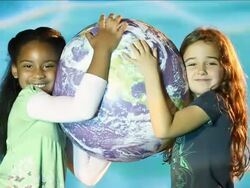 CU African-American girl and Caucasian curly haired girl hugging world / Miami, Florida, United States  Stock Footage