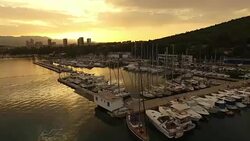 AERIAL Marina and city on the coast Stock Footage
