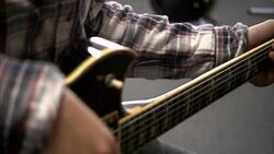 A musician holds a guitar in a guitar shop. Stock Footage