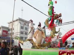 MS PAN TD Children dressed as ancient figures stand on specially designed machinery covered by clothes on tractor during shehuo celebrations, Shehuo is traditional festive folk celebration during chinese spring festival AUDIO / xi'an, shaanxi, china Stock Footage