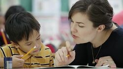 Teacher works with her elementary school students in class Stock Footage