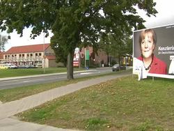 Defaced election poster featuring Angela Merkel News Clip