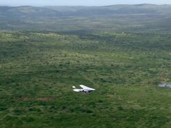 WS AERIAL TS View of Light aircraft flying over with forest / iSimangaliso Wetland Park, Kwazulu Natal, South Africa Stock Footage