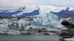 Melting ice at the Jokulsarlon ice lagoon, one of the most visited places in Iceland. It has been created by the rapid retreat of the Breidamerkurjokull glacier which sweeps down off the Vatnajokull ice cap. Ice bergs calve off the front and float into the Stock Footage
