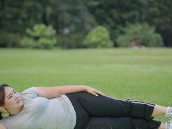 Fat woman lying by exercise leg upwards Stock Footage