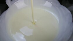 pouring white chcolate. close up. Slow motion. Stock Footage