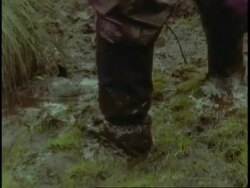 CU feet walking through deep mud, Uganda, Africa Stock Footage