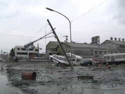 Destruction caused by tsunami after magnitude 9 Tohoku earthquake, north east Japan, March 2011. Wid shot of cars lying piled in thick mud after tsunami in Ishinomaki City,  Miyagi Prefecture Stock Footage